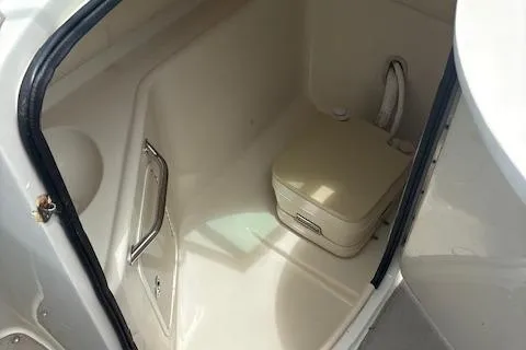 Slide: The Image of 2006 Sea Ray 240SD Bowrider interior with compact marine toilet. - 9