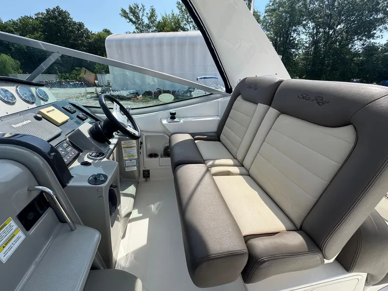 Slide: The Image of 2014 Sea Ray 330 Sundancer cockpit with plush seating and modern controls. - 10