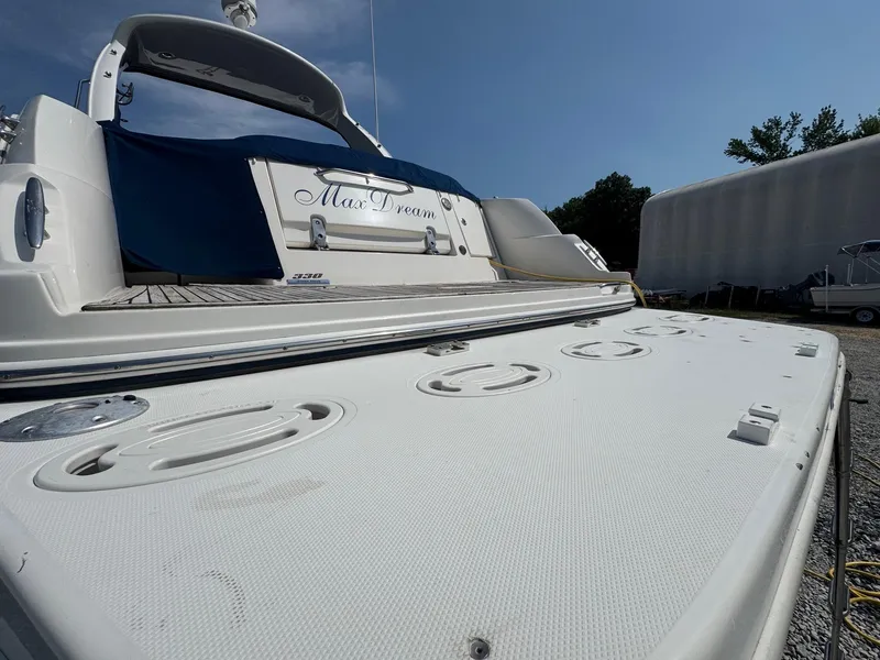 Slide: The Image of 2014 Sea Ray 330 Sundancer yacht docked, rear view with "Max Dream" nameplate. - 11