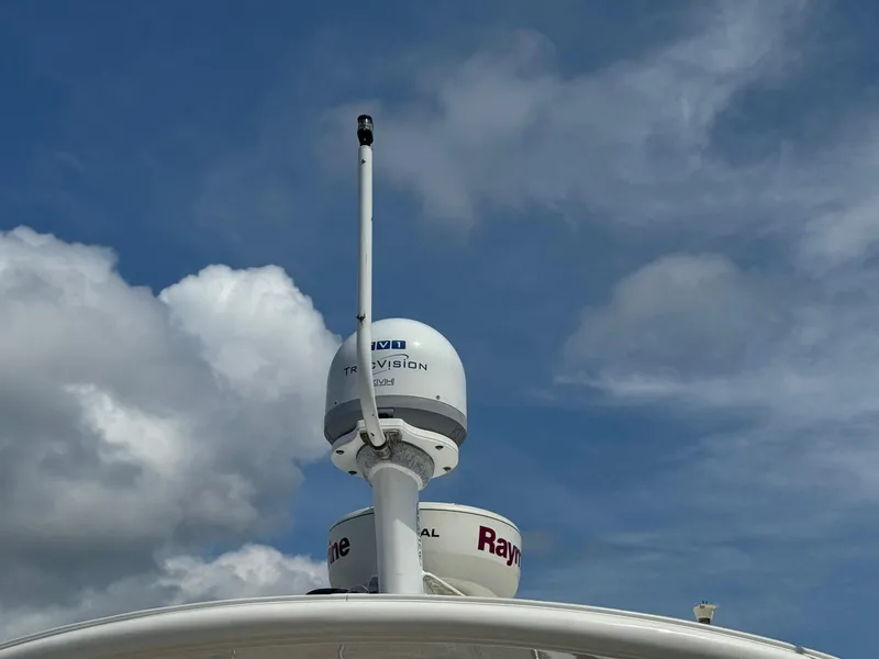 Slide: The Image of Radar and satellite equipment on a 2014 Sea Ray 330 Sundancer against a cloudy sky. - 14