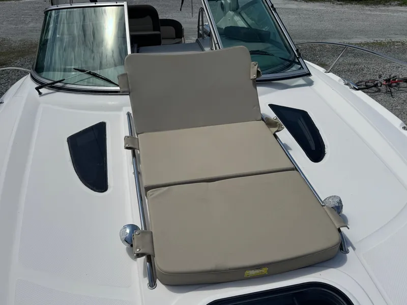 Slide: The Image of 2014 Sea Ray 330 Sundancer with beige sunpad on deck, featuring sleek design elements. - 16