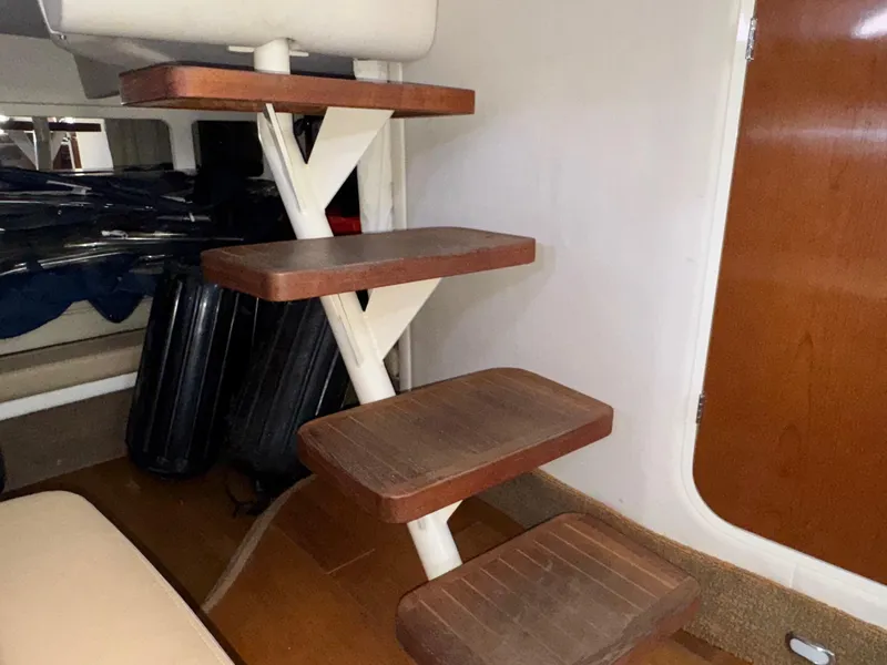 Slide: The Image of Interior stairs of a 2014 Sea Ray 330 Sundancer yacht, featuring wooden steps. - 29