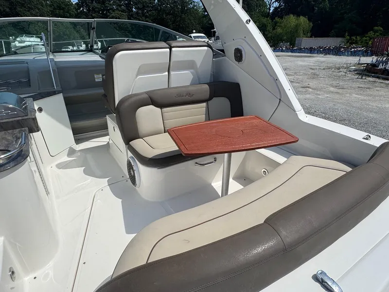 Slide: The Image of 2014 Sea Ray 330 Sundancer interior with seating and wooden table. - 3