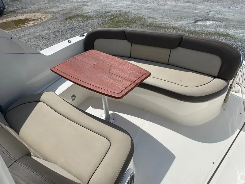 Slide: The Image of 2014 Sea Ray 330 Sundancer boat seating area with wooden table. - 7