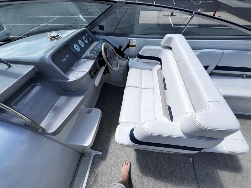 Slide: The Image of 1999 Formula 33 SS boat interior with white seating and dashboard controls. - 10