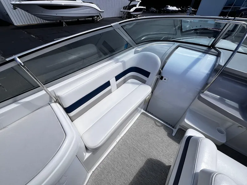 Slide: The Image of 1999 Formula 33 SS boat interior with white seating and blue accents. - 11