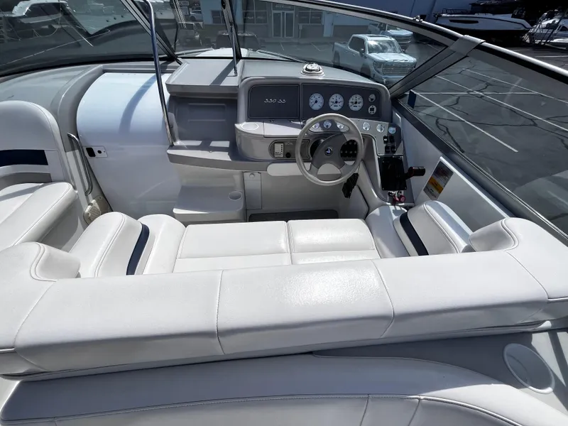 Slide: The Image of 1999 Formula 33 SS boat interior with white seating and modern dashboard controls. - 12