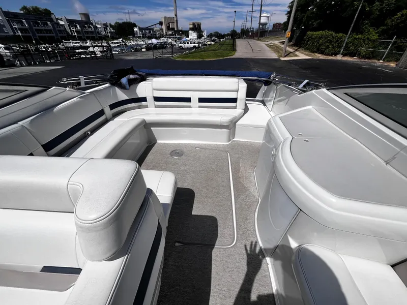 Slide: The Image of 1999 Formula 33 SS boat interior with white seating and carpeted floor, dockside view. - 15