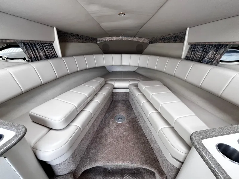 Slide: The Image of 1999 Formula 33 SS boat interior with plush seating and modern design. - 17