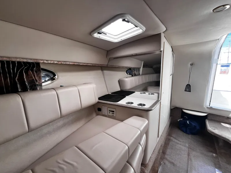 Slide: The Image of Interior of a 1999 Formula 33 SS boat with beige seating and compact kitchenette. - 19