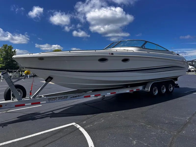 Slide: The Image of 1999 Formula 33 SS boat on trailer under blue sky with clouds. - 6
