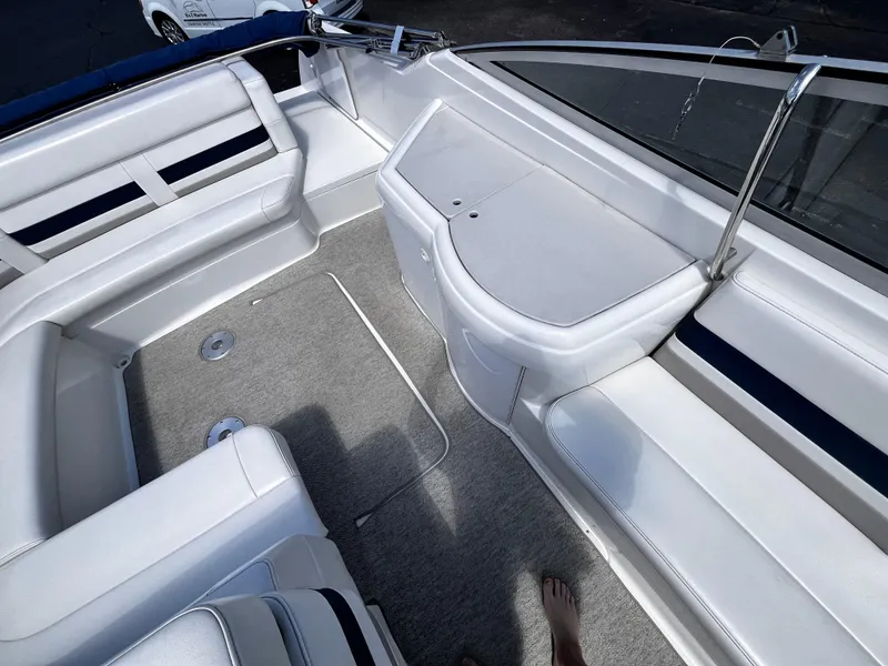 Slide: The Image of 1999 Formula 33 SS boat interior with white seating and carpeted floor. - 9