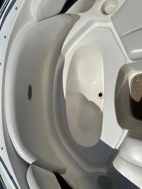 Slide: The Image of Interior seating of a 2002 Chaparral 196 SSi boat, featuring white upholstery. - 13