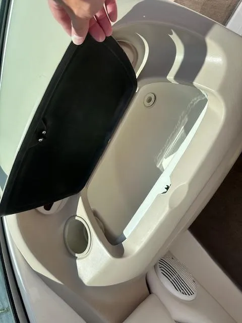 Slide: The Image of Open storage compartment in 2002 Chaparral 196 SSi boat, showing cup holders and speaker. - 18