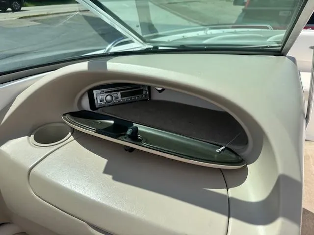 Slide: The Image of Interior of a 2002 Chaparral 196 SSi boat showing an open glove compartment with a stereo system. - 19