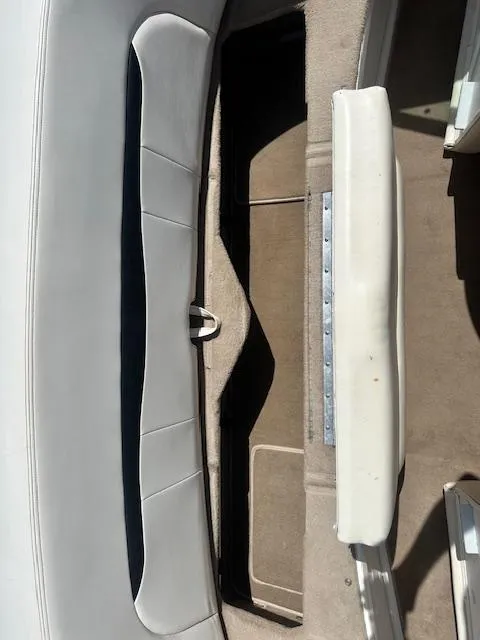 Slide: The Image of Interior view of a 2002 Chaparral 196 SSi boat, featuring white seating and carpeted flooring. - 21