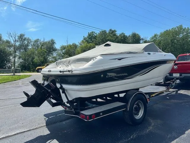 Slide: The Image of 2002 Chaparral 196 SSi boat on trailer, covered, parked outdoors. - 25