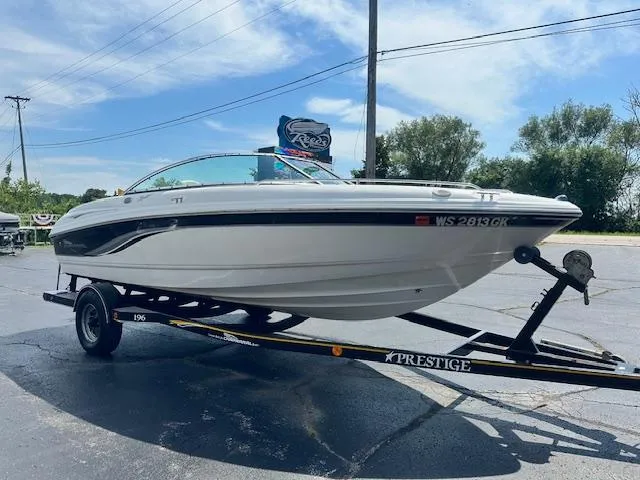 Slide: The Image of 2002 Chaparral 196 SSi boat on trailer, parked outdoors under a clear sky. - 4