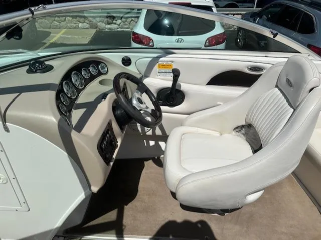 Slide: The Image of Interior of a 2002 Chaparral 196 SSi boat with white seating and dashboard controls. - 8