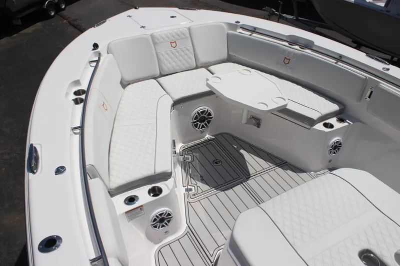 Slide: The Image of Luxurious seating area on 2025 Sea Fox 328 Commander boat with white upholstery and table. - 11