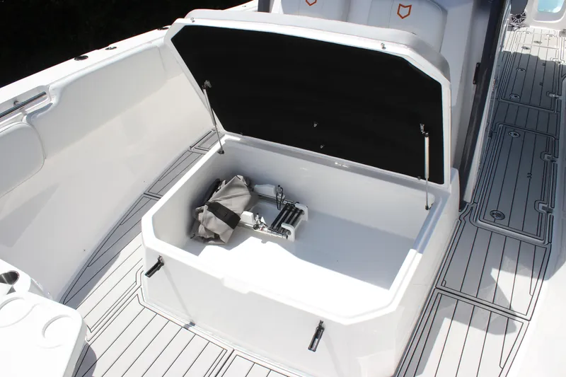 Slide: The Image of 2025 Sea Fox 328 Commander boat storage compartment with open lid and accessories. - 14