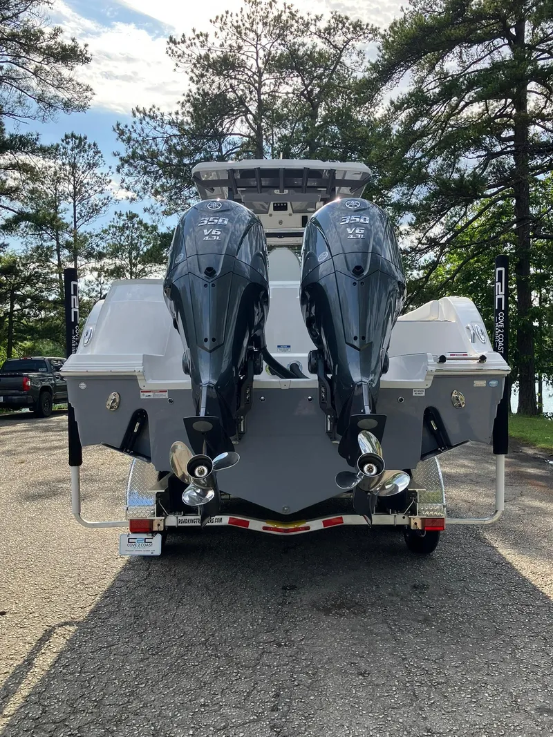 Slide: The Image of 2025 Sea Fox 328 Commander boat with dual outboard engines on a trailer. - 2