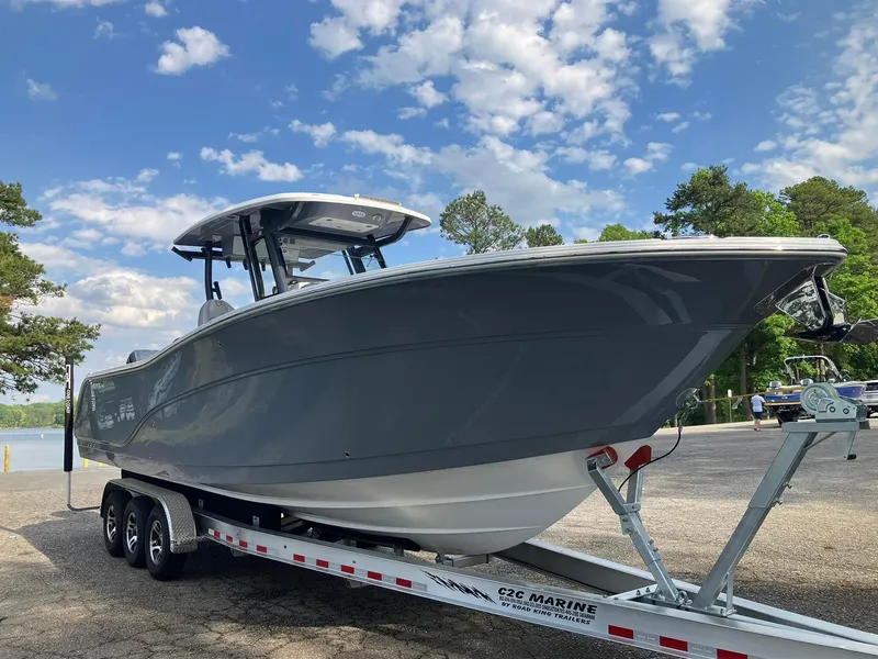 Slide: The Image of 2025 Sea Fox 328 Commander boat on trailer under blue sky. - 5
