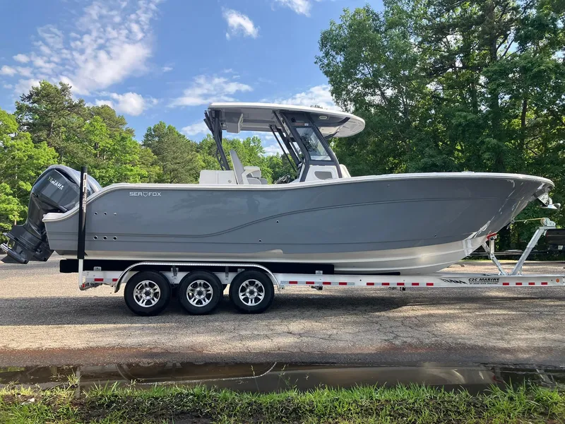 Slide: The Image of 2025 Sea Fox 328 Commander boat on trailer, parked outdoors. - 8