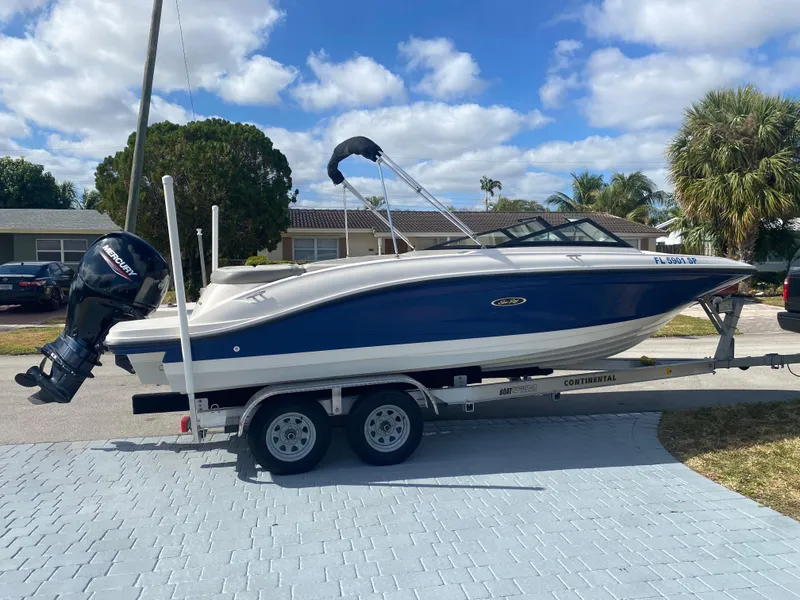 Slide: The Image of 2020 Sea Ray SPX 210 Outboard boat on trailer, parked in residential area. - 3