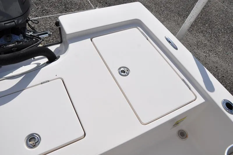 Slide: The Image of 2005 Pathfinder 2200 boat deck with storage compartments and engine detail. - 11