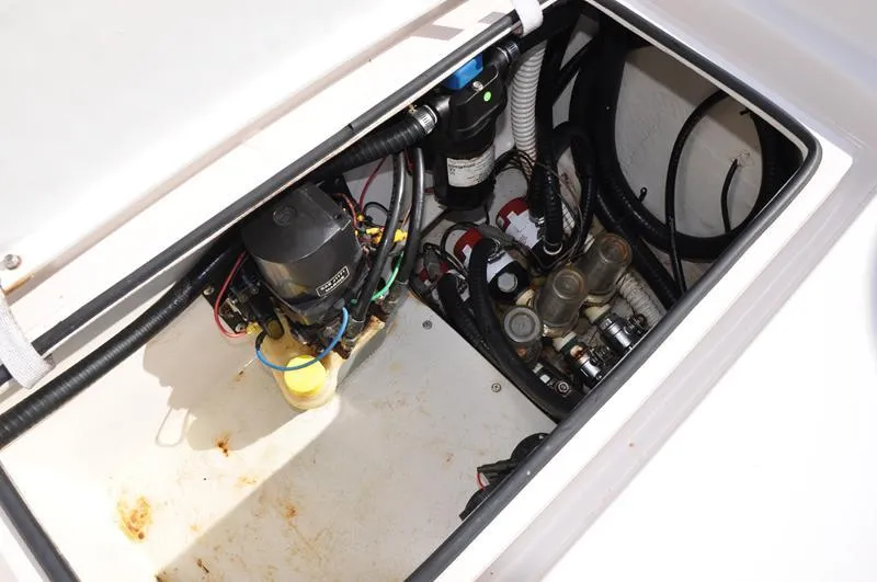 Slide: The Image of 2005 Pathfinder 2200 boat compartment with wiring and mechanical components. - 12