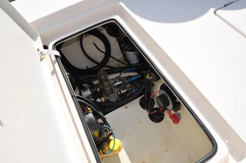 Slide: The Image of Open compartment of a 2005 Pathfinder 2200 boat showing internal components and wiring. - 13