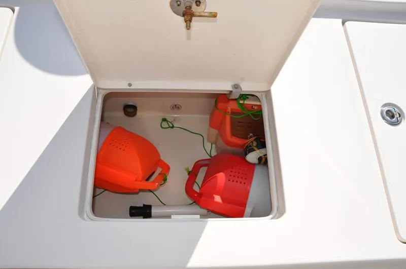 Slide: The Image of Storage compartment on a 2005 Pathfinder 2200 boat with red fuel containers. - 14