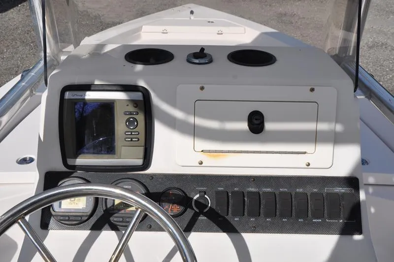 Slide: The Image of 2005 Pathfinder 2200 boat dashboard with steering wheel and navigation controls. - 19