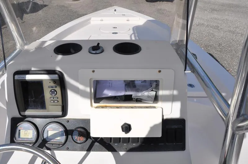 Slide: The Image of 2005 Pathfinder 2200 boat console with gauges and storage compartment. - 20
