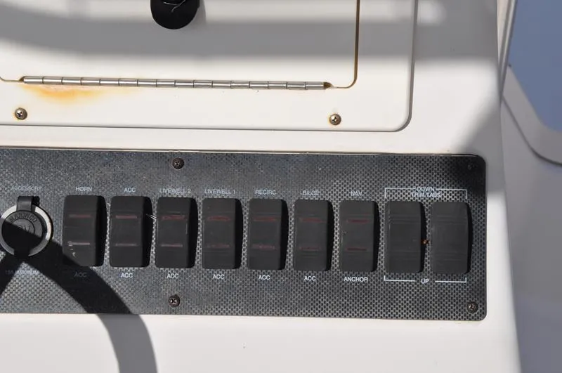 Slide: The Image of Control panel of a 2005 Pathfinder 2200 boat with multiple switches. - 21