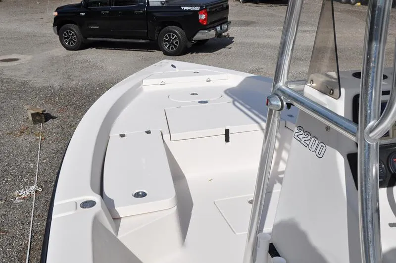 Slide: The Image of 2005 Pathfinder 2200 boat interior with a black truck in the background. - 23
