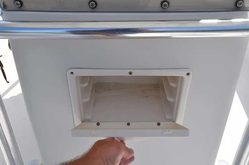 Slide: The Image of Hand opening compartment on 2005 Pathfinder 2200 boat console. - 25