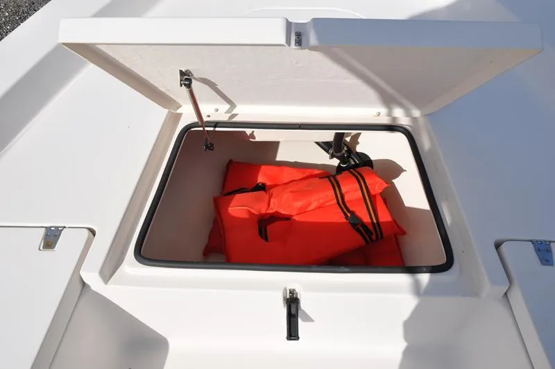 Slide: The Image of Open storage compartment on 2005 Pathfinder 2200 boat with orange life jackets inside. - 28