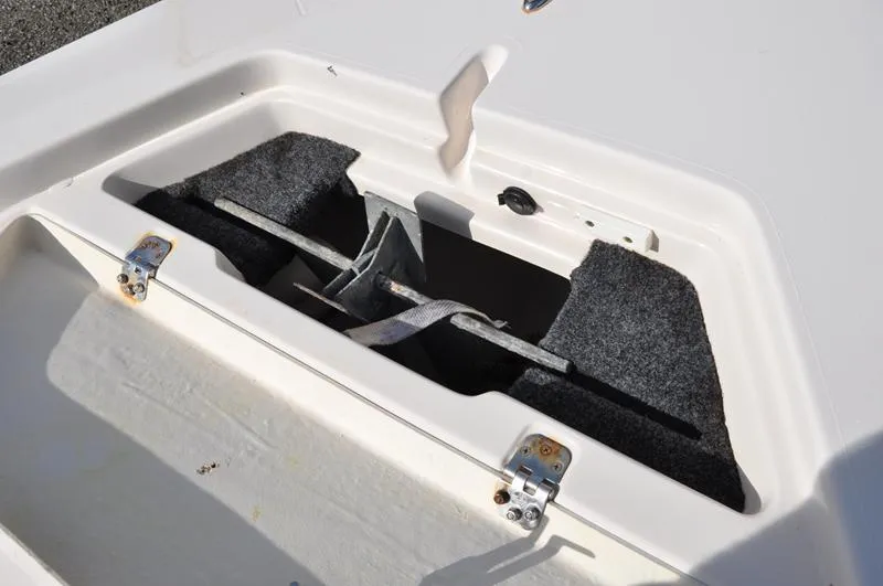 Slide: The Image of Anchor storage compartment on a 2005 Pathfinder 2200 boat, featuring secure latches. - 31