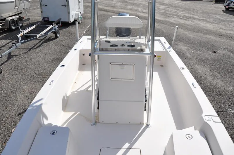 Slide: The Image of 2005 Pathfinder 2200 boat interior with center console and seating, parked on asphalt. - 32