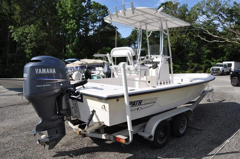 Slide: The Image of 2005 Pathfinder 2200 boat with Yamaha engine on a trailer, parked outdoors. - 4