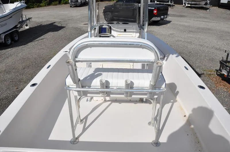 Slide: The Image of 2005 Pathfinder 2200 boat interior with seating and rod holders, parked on gravel. - 7