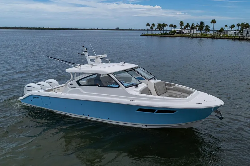 The Image of 2023 Pursuit DC 365 Dual Console boat on calm water, featuring sleek design and modern amenities. - 1
