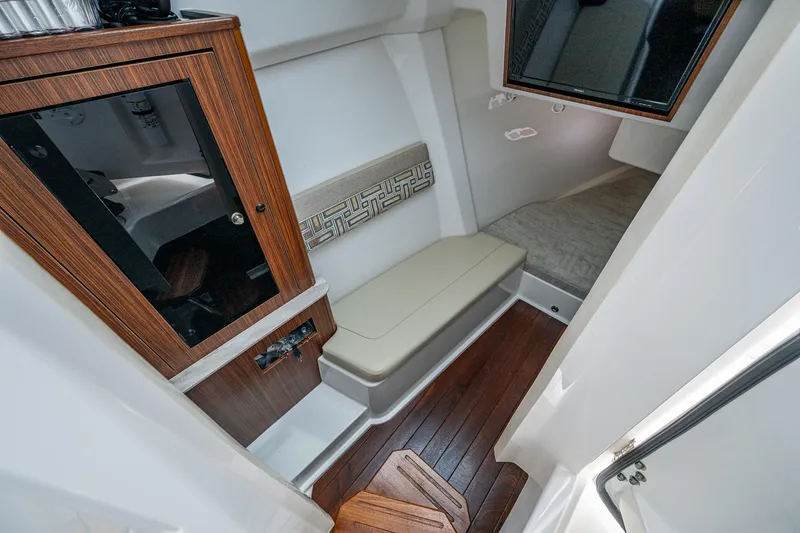 Slide: The Image of 2023 Pursuit DC 365 Dual Console cabin interior with wood accents and seating. - 13
