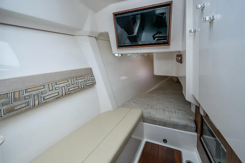 Slide: The Image of 2023 Pursuit DC 365 Dual Console cabin interior with seating and TV. - 15