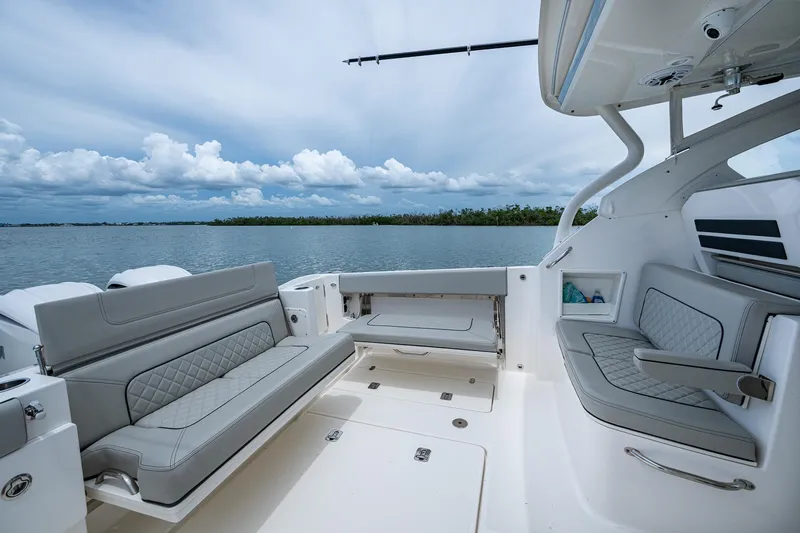 Slide: The Image of 2023 Pursuit DC 365 Dual Console boat interior with luxurious seating and scenic water view. - 21