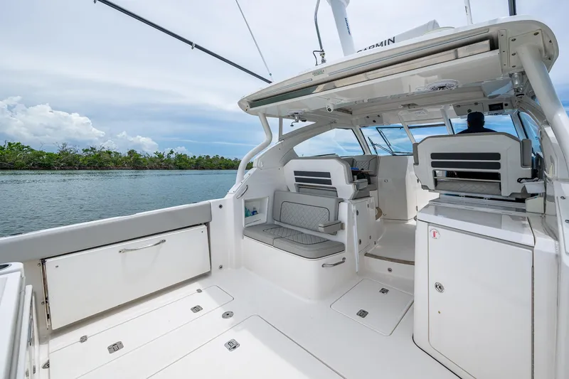 Slide: The Image of 2023 Pursuit DC 365 Dual Console boat interior with seating and water view. - 26