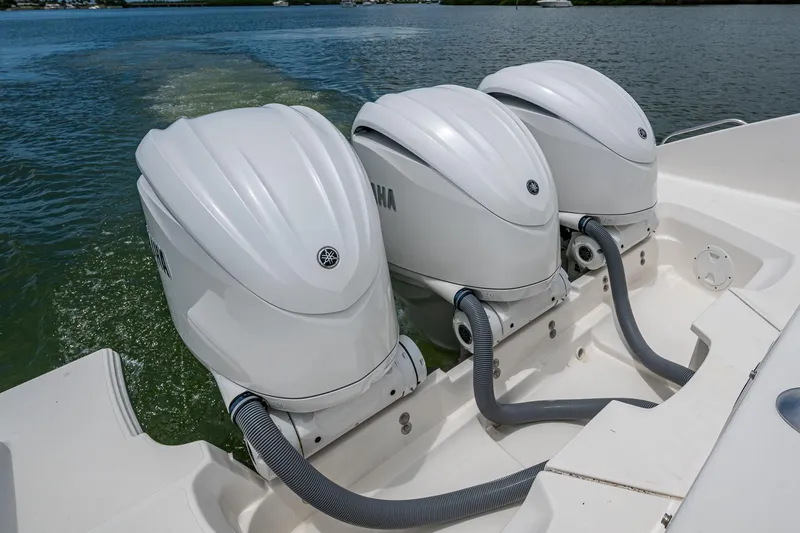 Slide: The Image of Triple Yamaha outboard engines on a 2023 Pursuit DC 365 Dual Console boat. - 35
