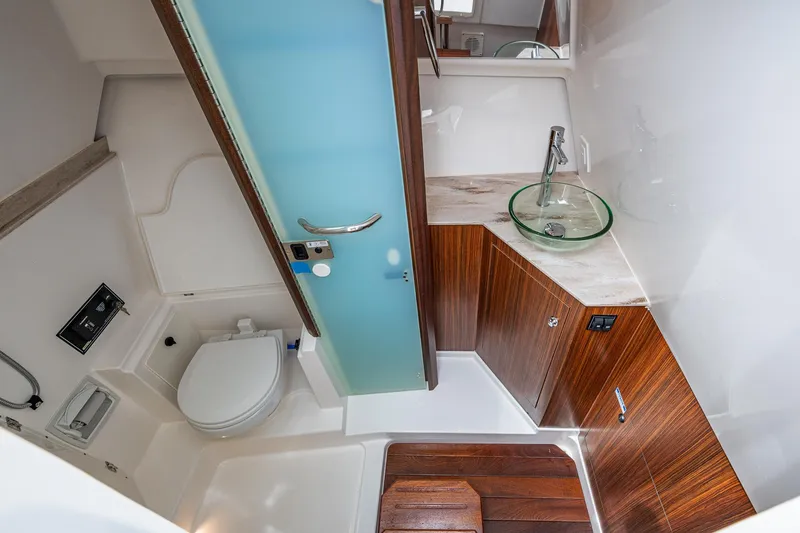 Slide: The Image of Luxurious bathroom in 2023 Pursuit DC 365 Dual Console boat with modern fixtures. - 36